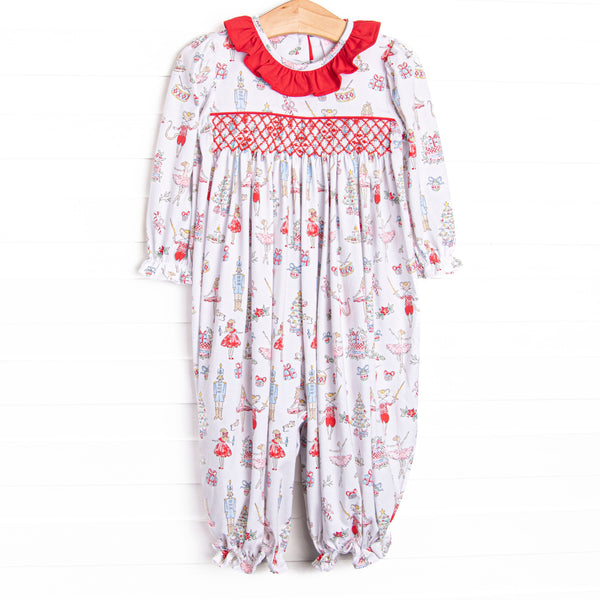 This romper features a Christmas print, dainty smocking, and red ruffle collar.