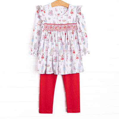 This set features a Christmas print, dainty smocking, and red leggings to match.