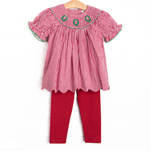  This set features a red gingham print, puff sleeves, and a trio of wreath smockings. Coordinating red leggings to match. 