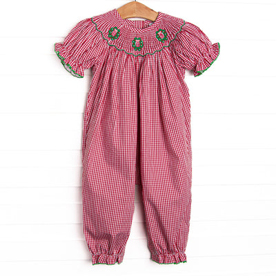 his romper features a red gingham print, puff sleeves, and a trio of wreath smockings.