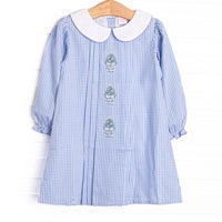 This dress features a blue gingham print, a peter pan collar, and Christmas Tree embroidery.