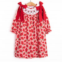  This dress features a poinsettia print, holly smocking, and big red corduroy bows on the shoulders. 