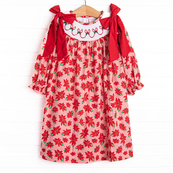  This dress features a poinsettia print, holly smocking, and big red corduroy bows on the shoulders. 