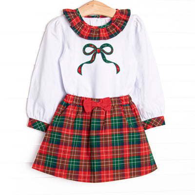 This set features a long sleeve top with green bow applique, and a ruffle collar. Coordinating red plaid skirt with a darling red bow detail to match.
