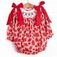 This bubble features a poinsettia print, holly smocking, and big red corduroy bows on the shoulders.
