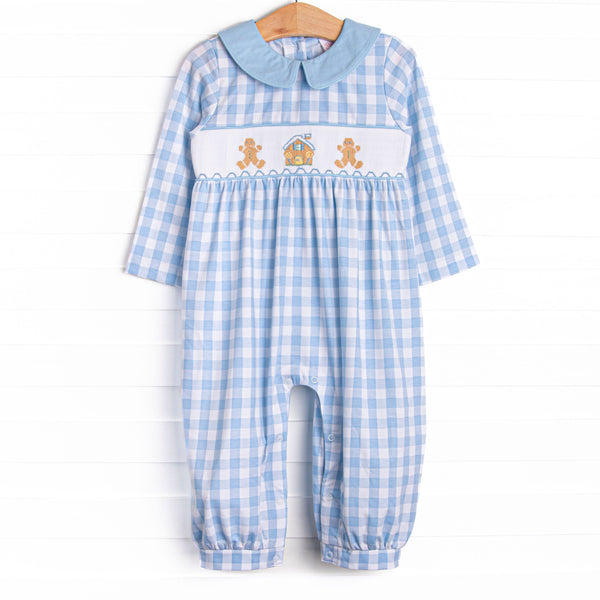 This romper features a blue check print, a blue peter pan collar, and a ginger snap smocking.