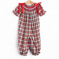  This romper features a red plaid print, puff sleeves, and red satin bows. 
