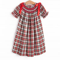 This dress features a red plaid print, puff sleeves, and red satin bows.