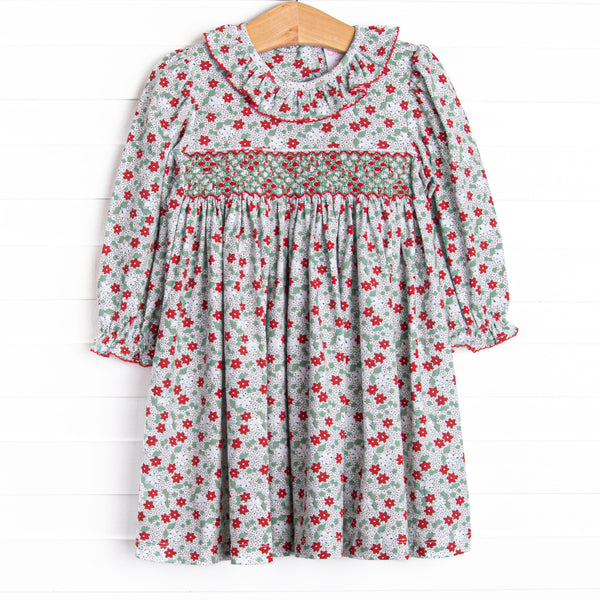 This dress features a red and green floral print, ruffle collar, and a dainty geometric smocking.