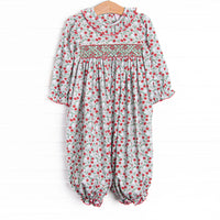 This romper features a red and green floral print, ruffle collar, and a dainty geometric smocking
