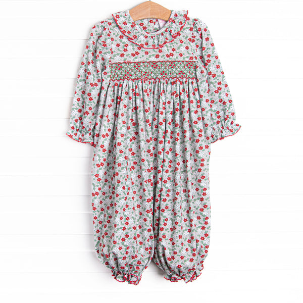 This romper features a red and green floral print, ruffle collar, and a dainty geometric smocking