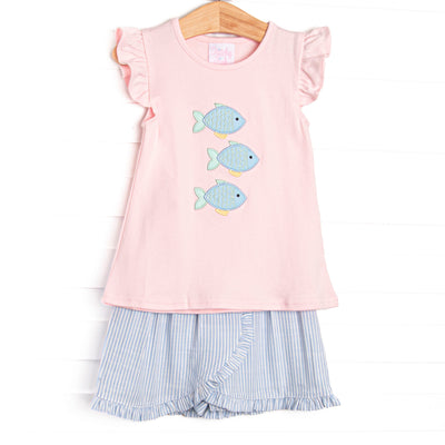 This set features a pink flutter sleeve top with a trio of fish appliques and a blue striped skort to match