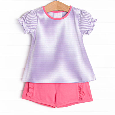  The set features a purple stripe top, pink trim, and pink ruffle shorts to match. 