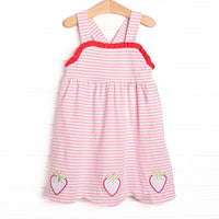 This dress features a pink striped print, red ruffle trim, and a trio of strawberries appliques.