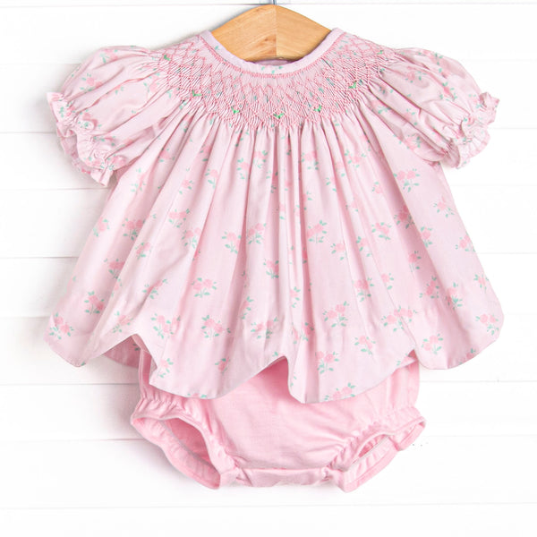  This set features a rose print, puff sleeves, and a dainty smocking. Coordinating pink diaper cover to match. 