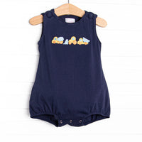 This bubble features a navy blue print, covered buttons, and a construction applique.