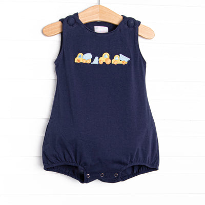 This bubble features a navy blue print, covered buttons, and a construction applique.