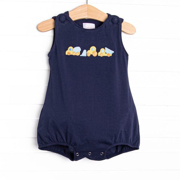 This bubble features a navy blue print, covered buttons, and a construction applique.