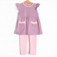  The&nbsp;set features&nbsp;purple&nbsp;stripes, pink ruffle trim, and pink knit leggings. 