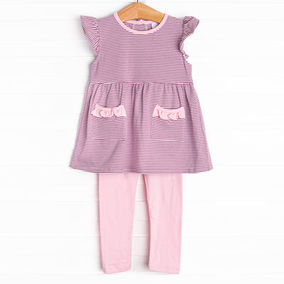  The&nbsp;set features&nbsp;purple&nbsp;stripes, pink ruffle trim, and pink knit leggings. 