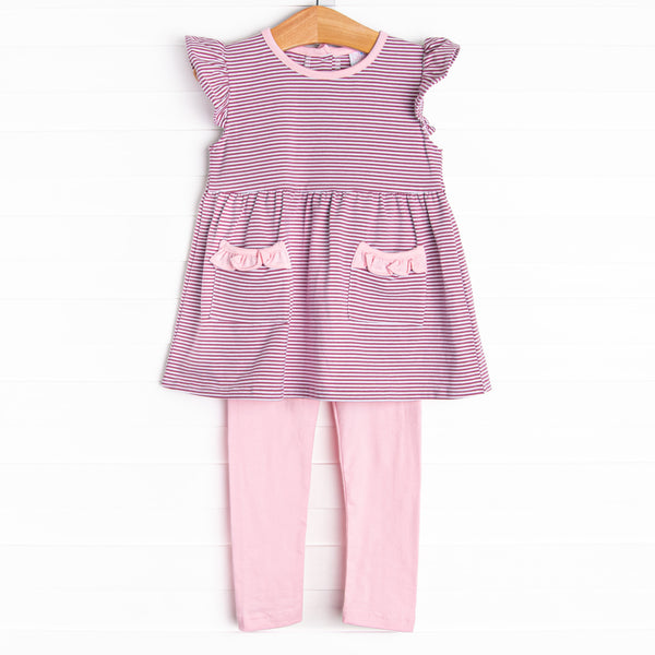  The&nbsp;set features&nbsp;purple&nbsp;stripes, pink ruffle trim, and pink knit leggings. 