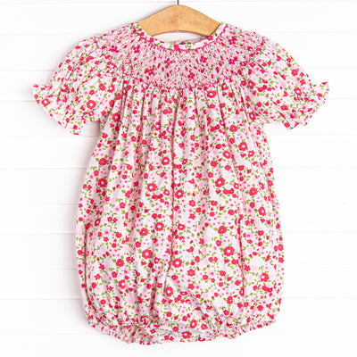  This bubble features a pink floral print, snaps on the stride, and a floral smocking. 
