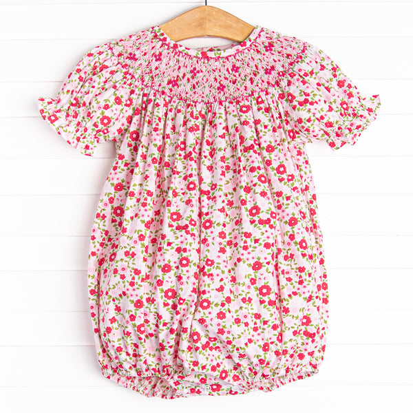  This bubble features a pink floral print, snaps on the stride, and a floral smocking. 