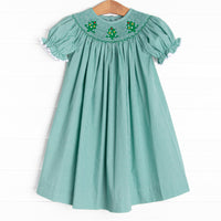 This bishop dress is perfect for the holiday season! It is featured in green gingham and a trio of embroidered Christmas trees and smocking along the neckline!