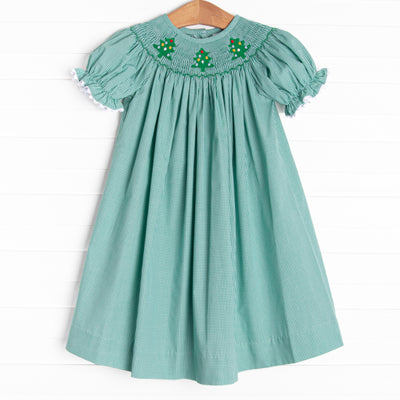 This bishop dress is perfect for the holiday season! It is featured in green gingham and a trio of embroidered Christmas trees and smocking along the neckline!