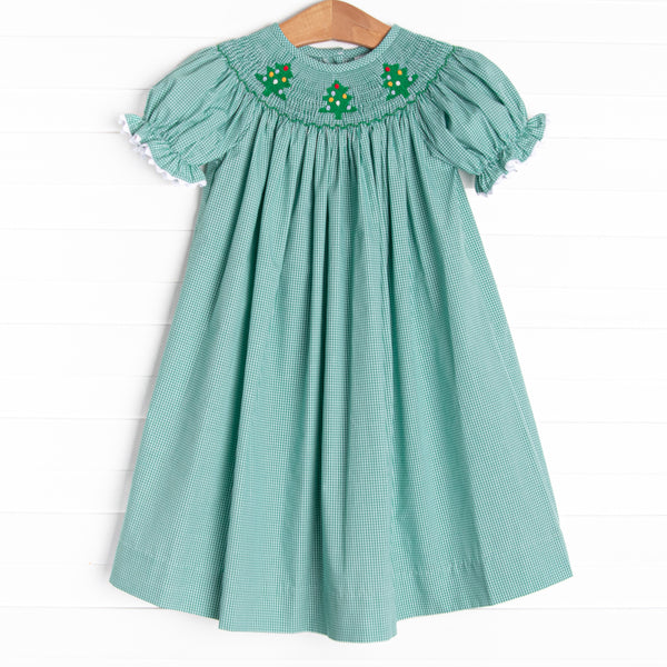 This bishop dress is perfect for the holiday season! It is featured in green gingham and a trio of embroidered Christmas trees and smocking along the neckline!