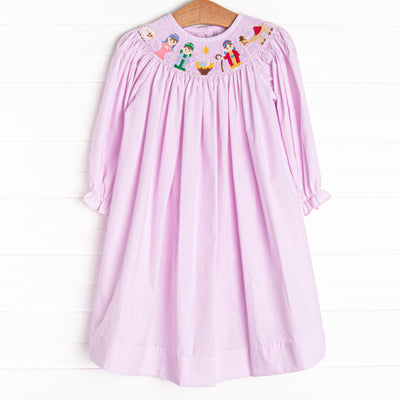 The dress features in pink gingham boasts adorable long puff sleeves and a smocked Christmas scene.