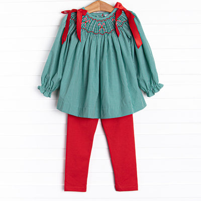 This set features a green gingham print, red satin bows in the shoulders, and candy cane smockings. Coordinating red leggings to match.
