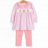 This set features a pink check print, a pink peter pan collar, and a ginger snap smocking. Coordinating pink leggings to match.