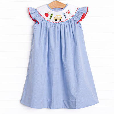 This dress features a blue mini gingham print, flutter sleeves, and a back to school smocking.