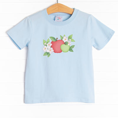  The shirt is featured in four colors: Soft Blue, Heather Gray, Ballerina Pink, and White. 