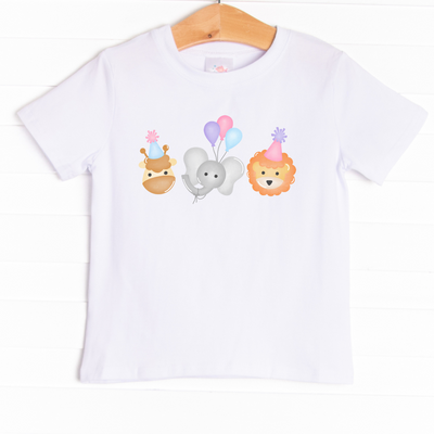 The shirt is featured in four colors; White, Heather Gray, Ballerina Pink, and Soft Blue with a festive graphic.