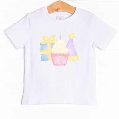 The shirt is featured in four colors; White, Heather Gray, Ballerina Pink, and Soft Blue with a festive graphic.