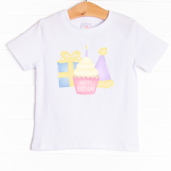 The shirt is featured in four colors; White, Heather Gray, Ballerina Pink, and Soft Blue with a festive graphic.