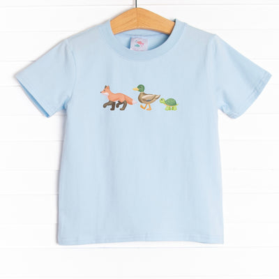 The shirt is featured in three colors: Soft Blue, Heather Gray, and White.