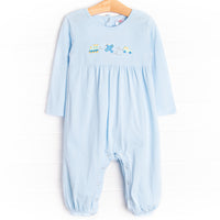 This romper features light blue knit material, snaps on the strides, and the cutest train, airplane and car embroidery.