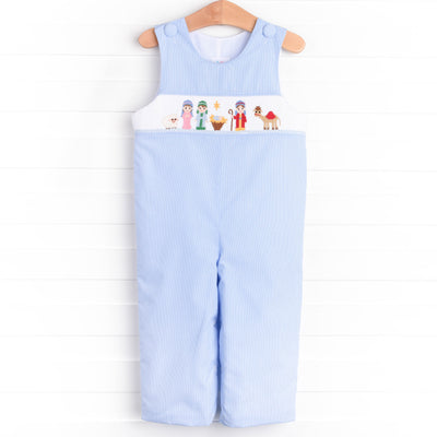  The Jon Jon featured in blue gingham boasts fabric buttons, snaps in the stride to make changing a breeze, and a smocked Christmas scene. 
